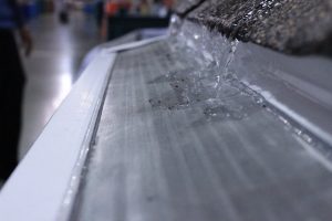 LeafFilter gutter guard on roofline with no debris and water flowing freely off roof.