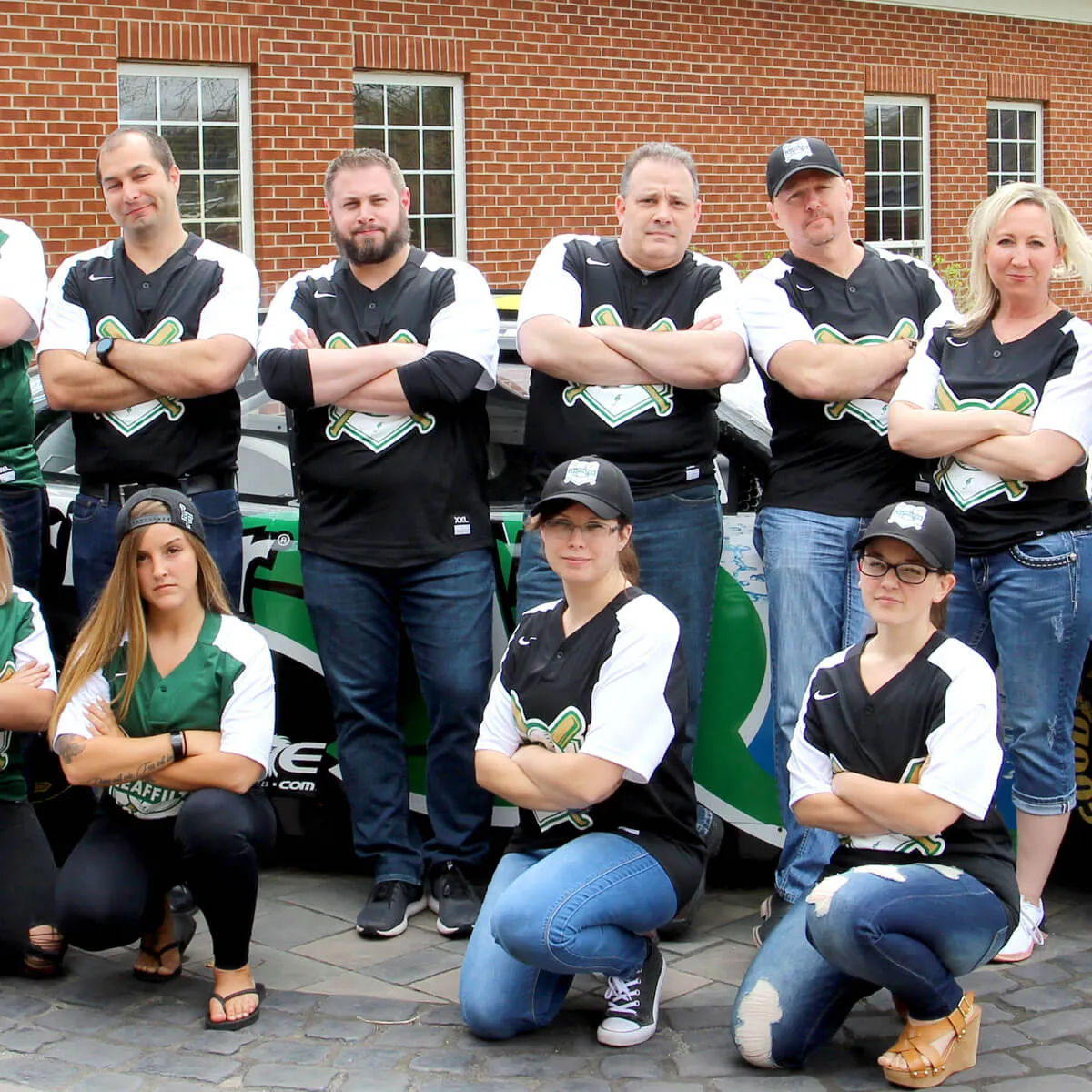 LeafFilter members pose in front of the company Nascar