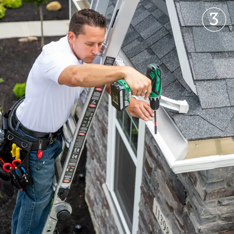 LeafFilter employee installing gutters on a home