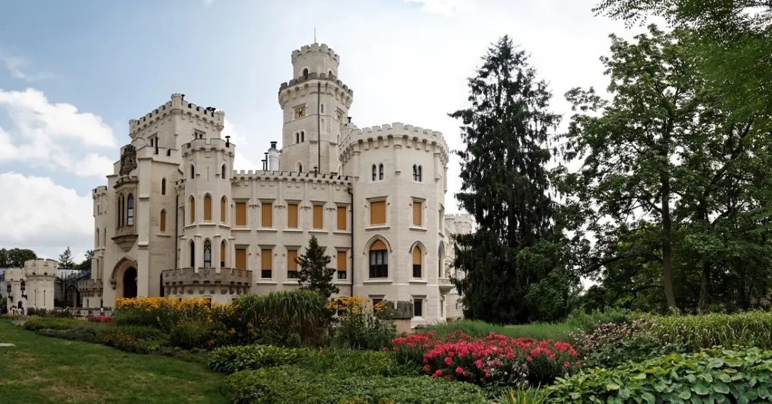 Castle set alongside trees and gardens