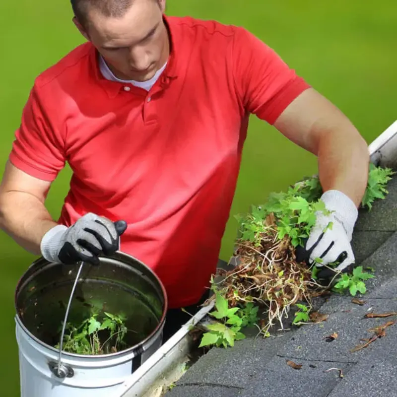 man cleaning dirty gutters