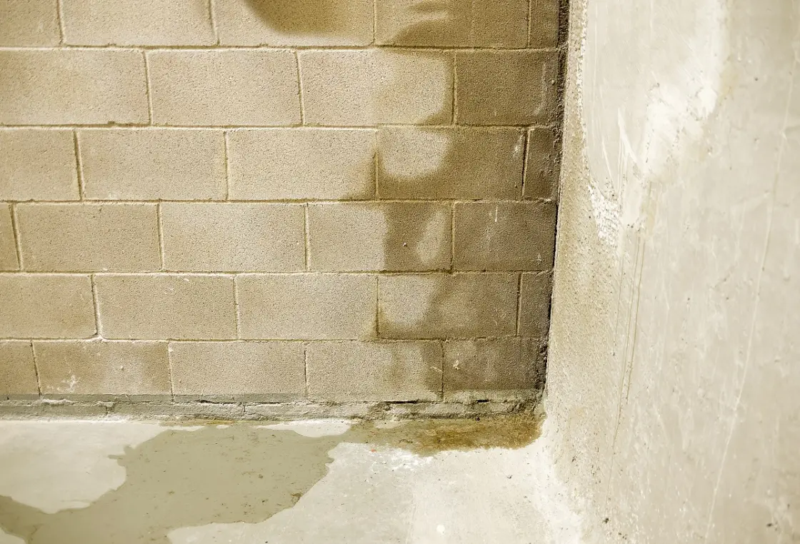 Water coming into a basement through the corner of a wall