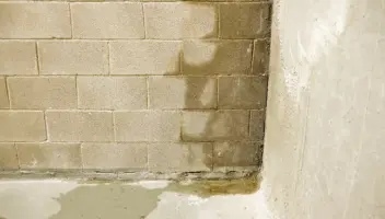 Water coming into a basement through the corner of a wall