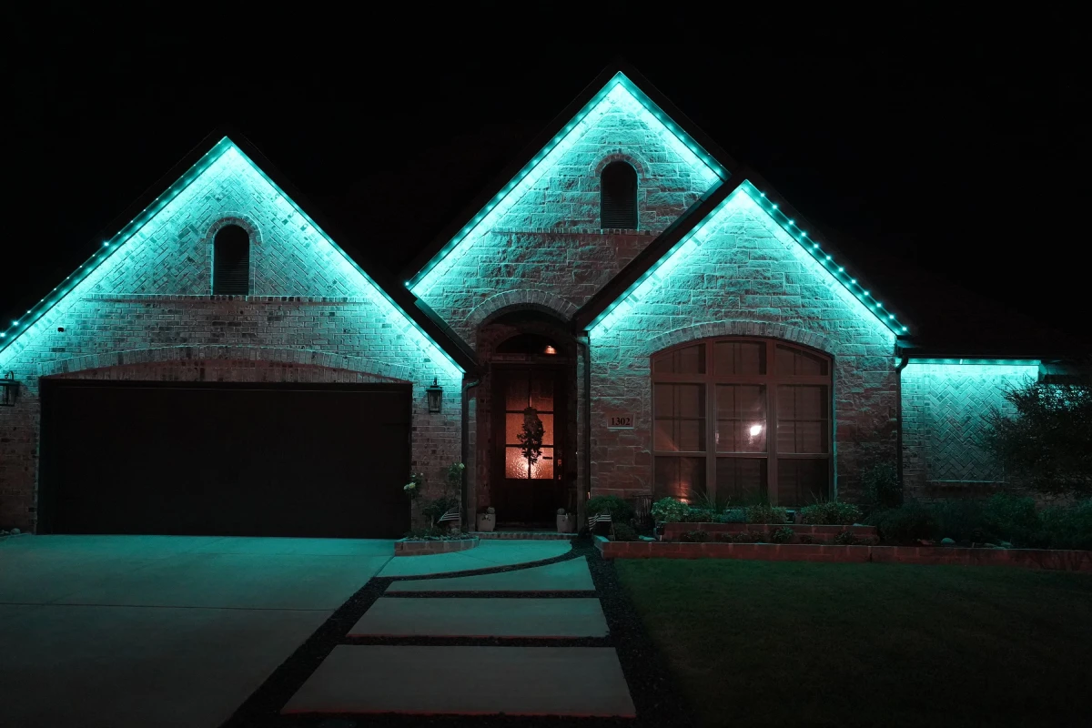 House lit up in teal lights for team pride