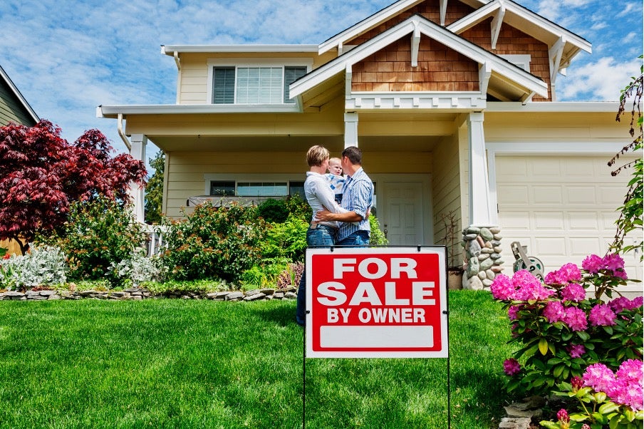Family standing infront of home with for sale sign. Getting ready for spring cleaning and home sale prep