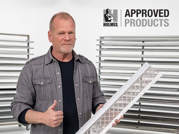 Mike Holmes holding LeafFilter gutter guard showing its a Mike Holmes approved product