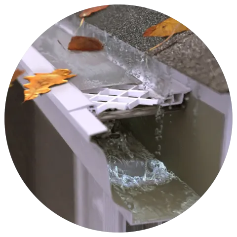 LeafFilter product with leaves sitting outside of the gutter