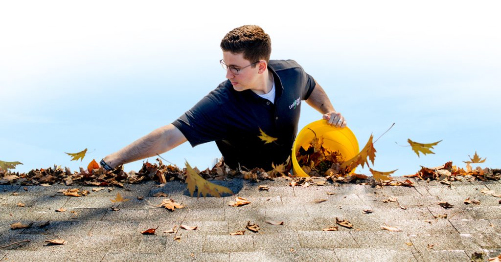 LeafFilter employee cleaning gutters of leaves and debris