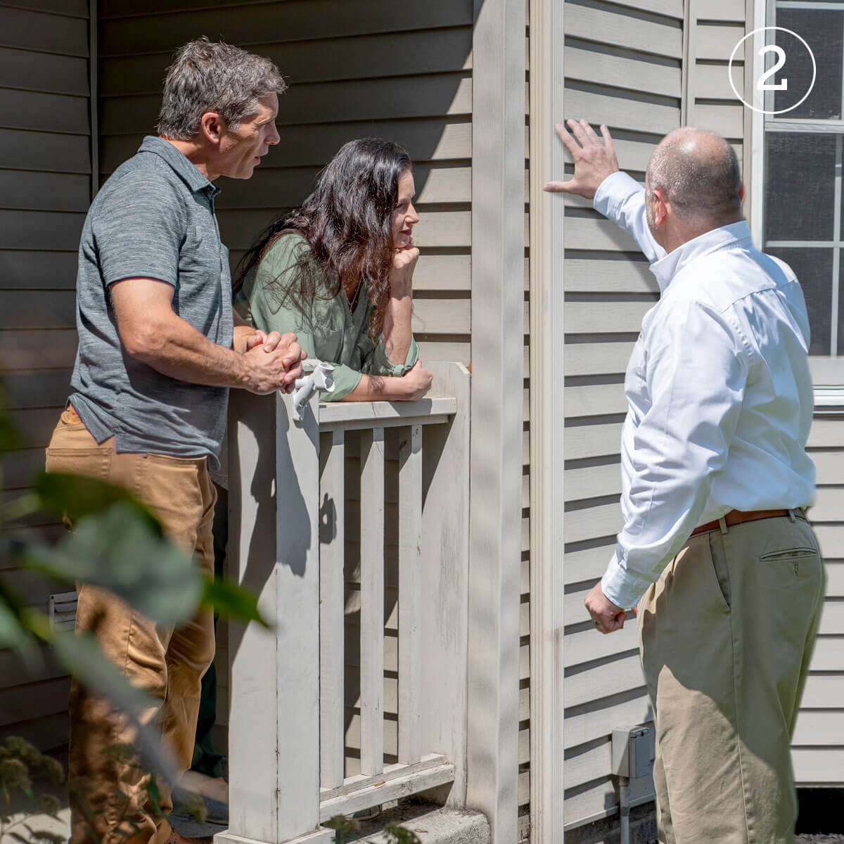 LeafFilter employee discussing installation options with husband and wife