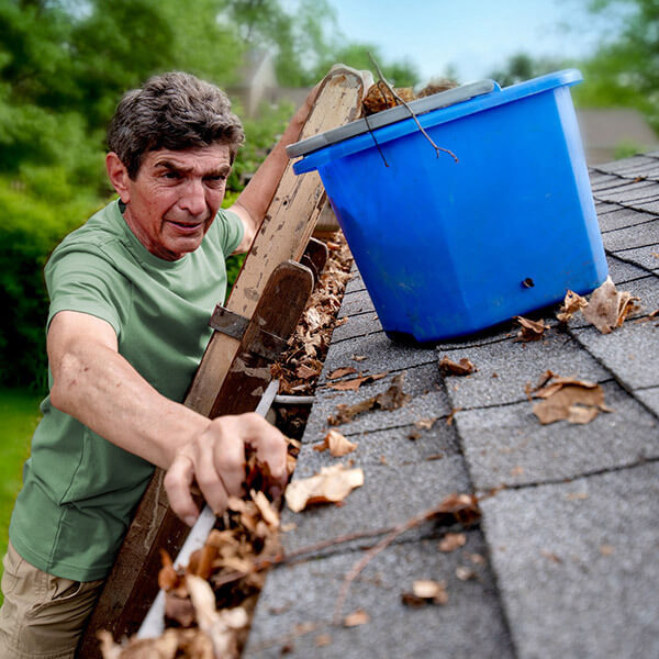 man cleaning dirty gutters